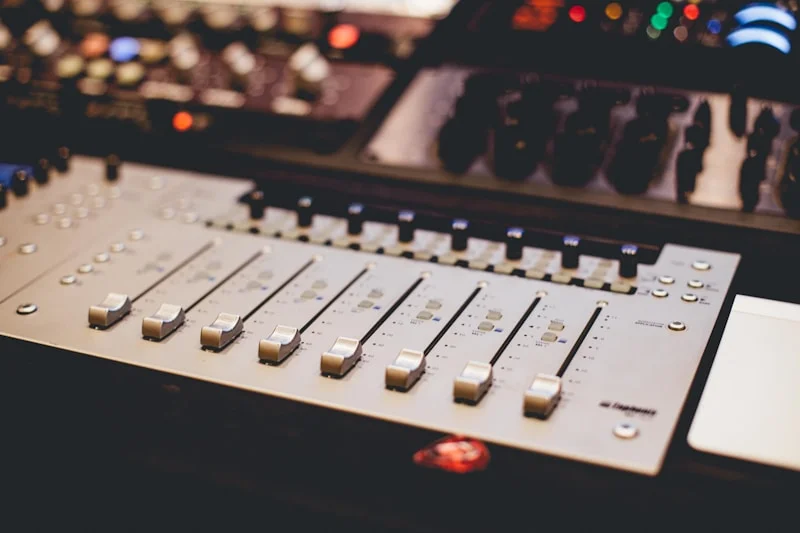 Mixing console under warm light, mid-show